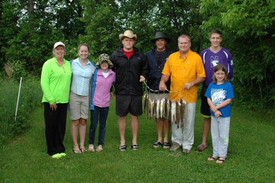 family with stringer of fish at Everett Bay Lodge on Lake Vermilion