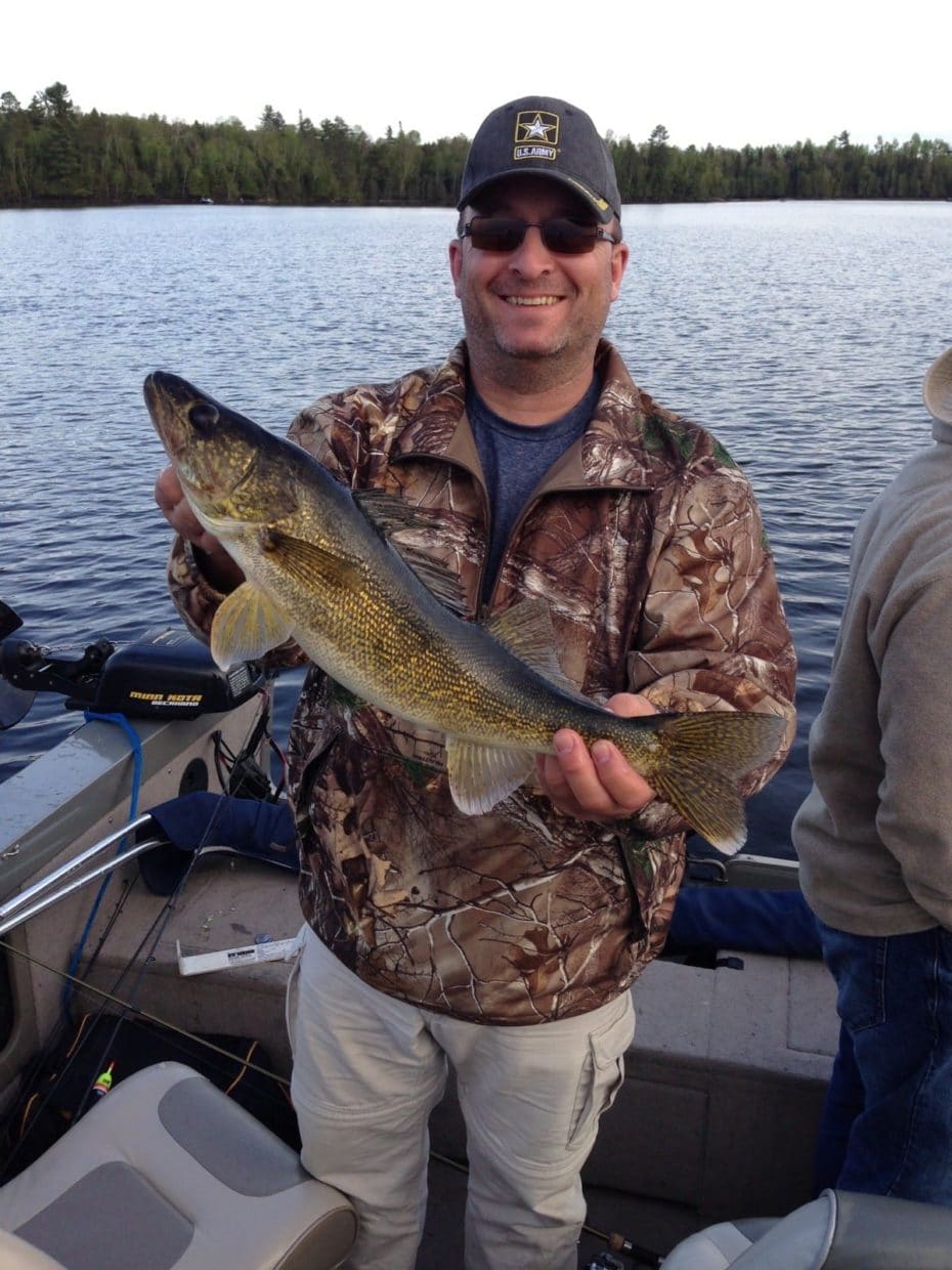 man holds walleye caught in Minnesota