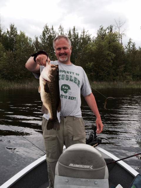 Man holding big largemouth bass on Lake Vermilion