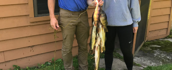 Man and daughter with stringer of fish