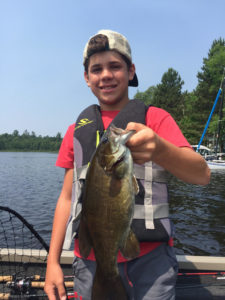 Boy holding smallmouth bass 