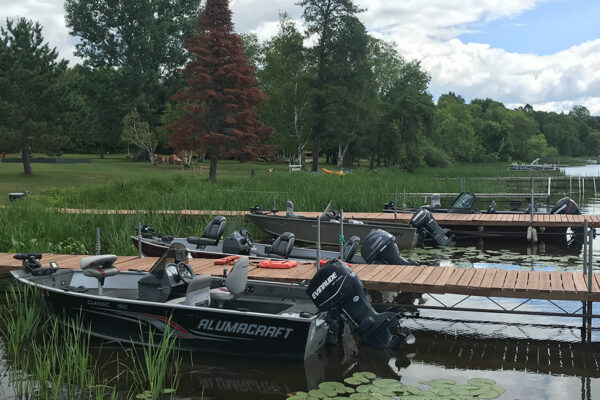 fishing boats with motors alongside docks